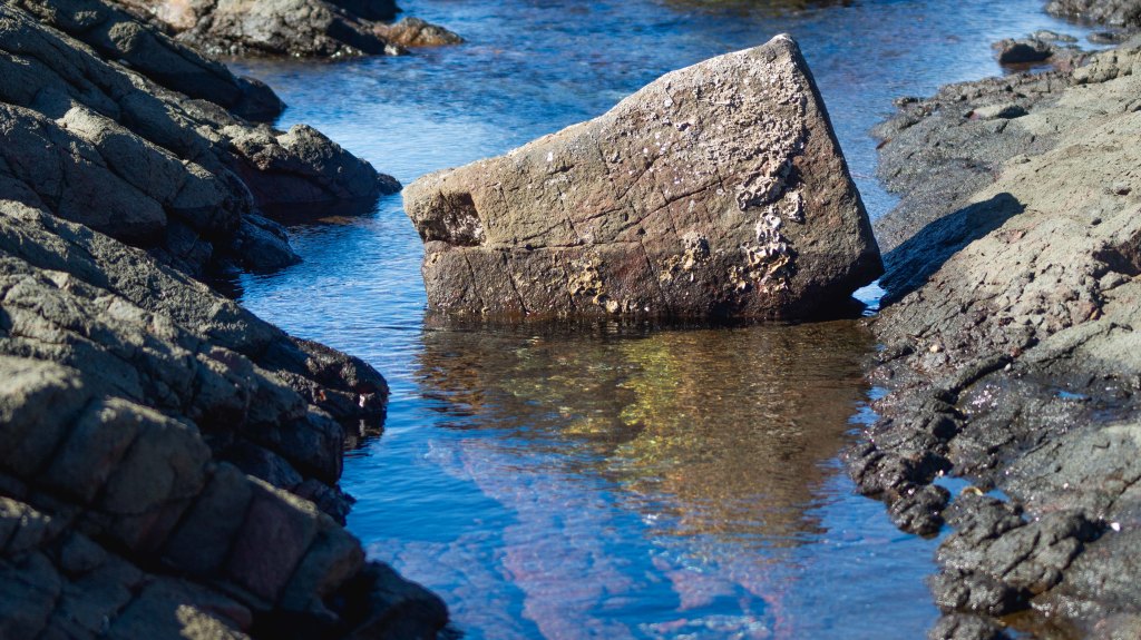 Rock pool with reflection in water